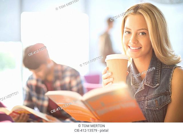 University student reading and drinking coffee