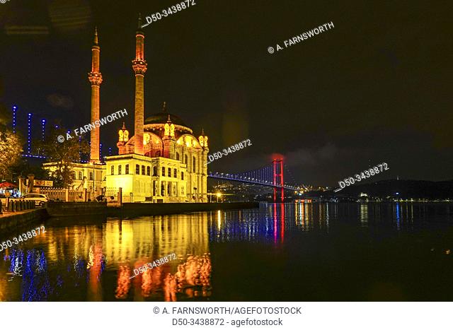 Istanbul, Turkey The Ortakoy Mosque under the Bosphorus Bridge, known officially as the 15 July Martyrs Bridge and unofficially as the First Bridge