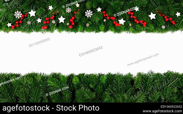 Christmas Border frame of tree branches and red berries and wooden decor on white background with copy space isolated