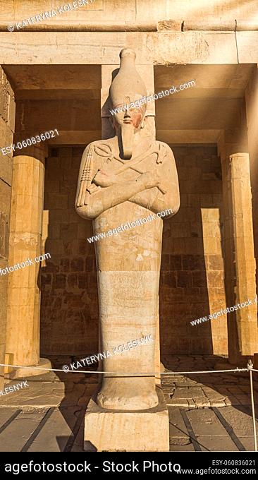 Statue in Hatshepsut temple under morning sunbeams, Egypt