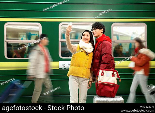 The young couple stood the station platform