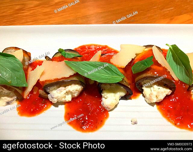 Cheese cream stuffed aubergines with basil and tomato sauce. Italy