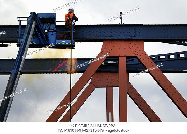 18 October 2018, North Rhine-Westphalia, Muelheim an der Ruhr: A worker separates part of the bridge with a welding torch