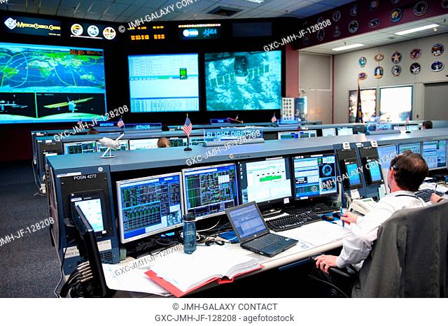 Flight director Chris Edelen monitors data at his console in the space station flight control room in the Mission Control Center at NASA's Johnson Space Center...