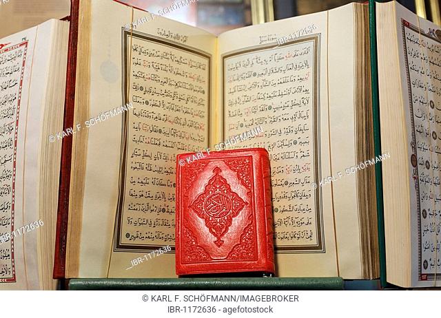 Little red book, pressed, in front of opened Koran, Arabic writing, book bazaar, Beyazit, Istanbul, Turkey