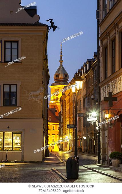 Dawn in Warsaw old town, Poland. Royal Castle tower in hte distance