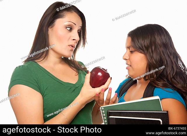 Hispanic mother and daughter with books and apple ready for school isolated on a white background