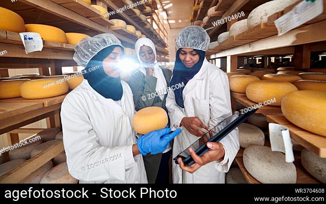 middle eastern black african muslim female business woman team in local cow and goat milk cheese food production company