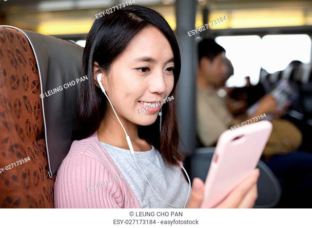 Woman listen to song on mobile phone