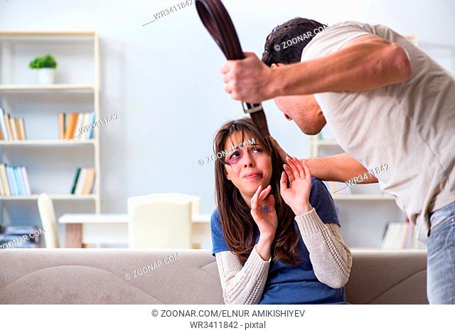 Desparate wife with aggressive husband in domestic violence concept