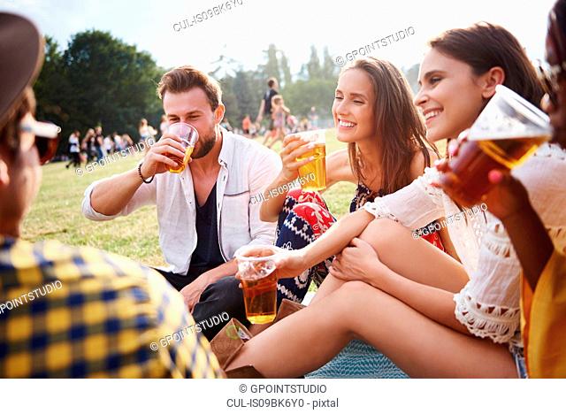 Friends sitting and enjoying music festival