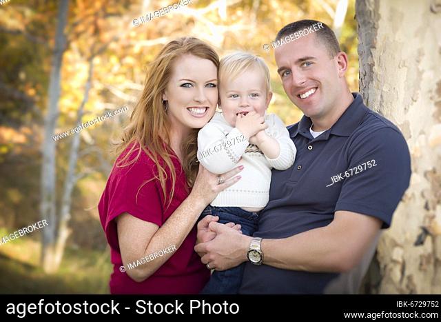 Young attractive parents and child portrait outdoors
