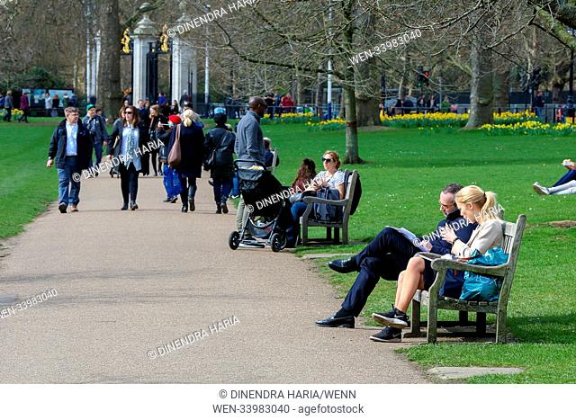Tourists enjoying the spring sunshine in St James Park, central London as temperatures likely to reach 13 degrees celsius in the capital