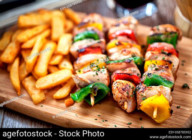 Chicken skewers with fries. High quality photo