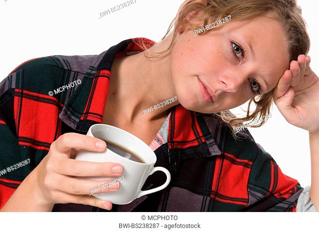 exhausted young manufacturer taking a coffee break