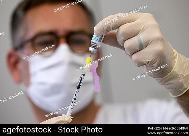 14 July 2022, Bavaria, Munich: An employee prepares a syringe with Bavarian Nordic's vaccine (Imvanex / Jynneos) against monkeypox at Klinikum rechts der Isar