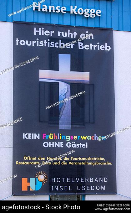 22 March 2021, Mecklenburg-Western Pomerania, Koserow: A protest poster of the Hotel Association Ostseeinsel Usedom against the ongoing closure of all tourist...