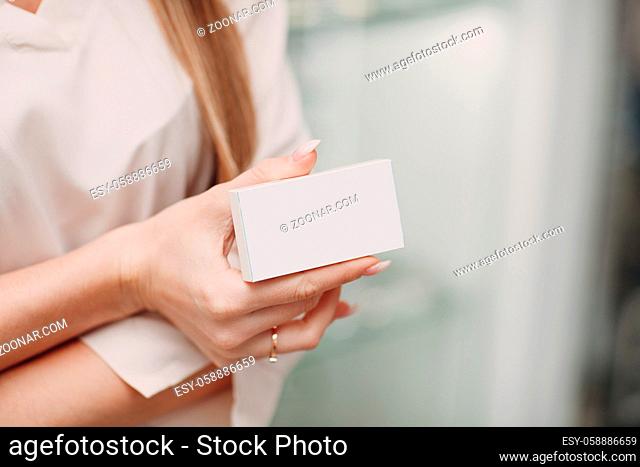 Woman hand holding white blank box package