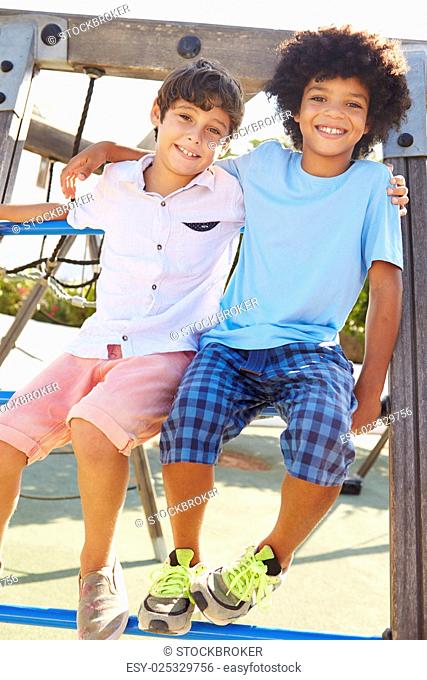 Portrait Of Two Boys On Playground Climbing Frame