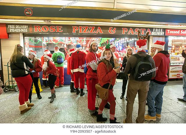 Christmas revelers arrive at Pennsylvania Station for the annual SantaCon in New York. Santacon, primarily a pub crawl in Santa and other Christmas related...