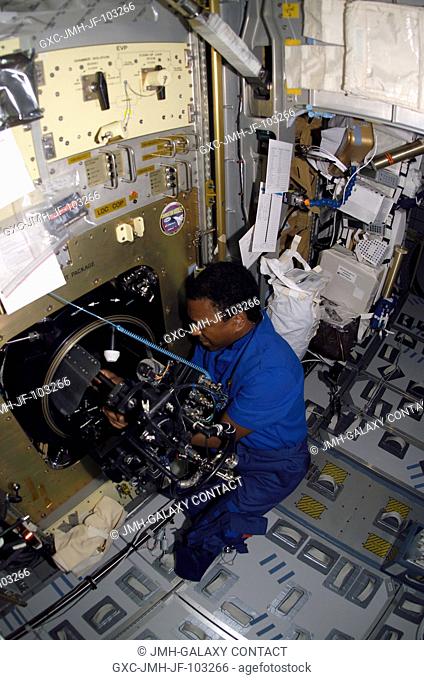 Astronaut Michael P. Anderson, STS-107 payload commander, works with the Combustion Module-2 (CM-2) facility in the SPACEHAB Research Double Module aboard the...