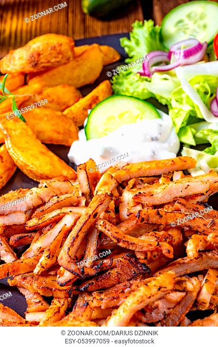 Rustic gyros plate it green salad and potato wedges