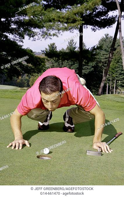 Pennsylvania, Pocono Mountains, Hawley, The Country Club at Woodloch Springs, golf course, male golfer, green, blowing ball, hole, humor
