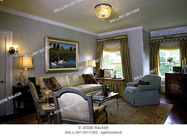 LIVING ROOMS: Traditional sitting area, special glaze painting Armour coat plaster paint on walls, painted cornices, gold drapes with soft folded shades