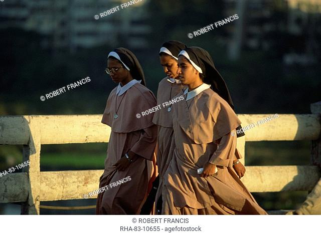Nuns crossing the Mula River, Pune, Maharashtra state, India, Asia