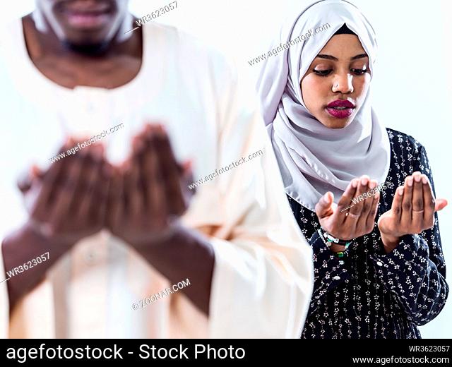 african muslim couple praying Allah by raising hands and making fatiha pray isolated on white background