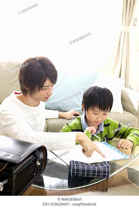 Son studying with father