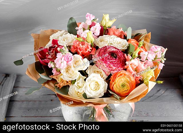 Bouquet of roses and Other colors flowers on wooden background, copy space