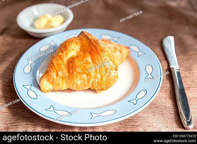 Fresh croissant and tasty butter for breakfast