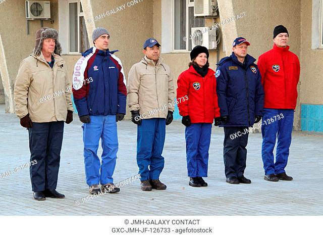 The Expedition 26 backup and prime crews attend ceremonies outside their Cosmonaut Hotel crew quarters in Baikonur, Kazakhstan Dec
