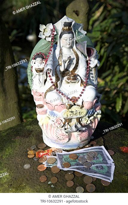 Coins And Money Offerings Placed In Front Of Porcelain Buddha Buddhapadipa Thai Temple Wimbledon