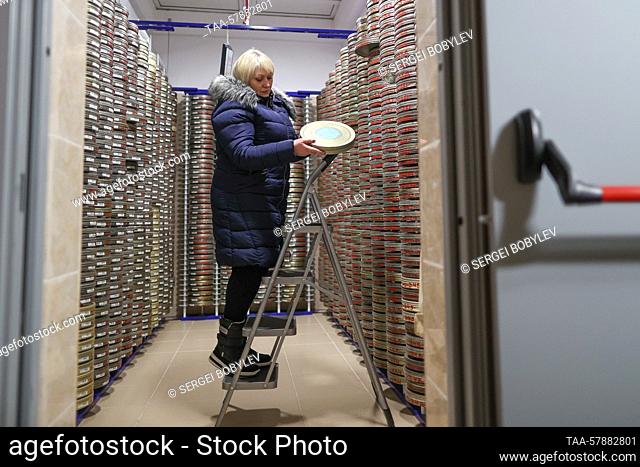 RUSSIA, MOSCOW REGION - MARCH 15, 2023: A woman takes in her hands a film can from a nitrate film vault on the premises of Gosfilmofond