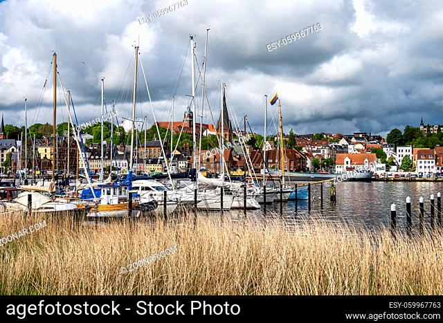 Sail boats in the port of Flensburg, St. Jorgen's Church in the background. Schleswig-Holstein in Germany, Europe