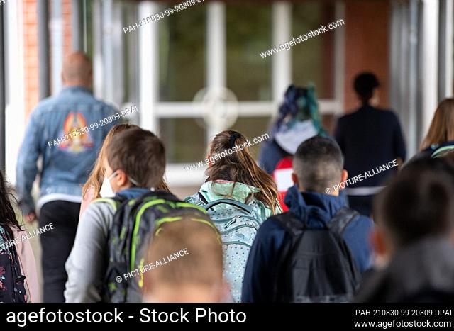 30 August 2021, Hessen, Nidda: Students walk to the classroom for the enrollment of a fifth grade class at Alteburg School