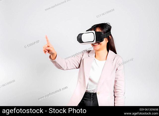 Smiling woman confidence wearing VR headset device touching air during virtual reality experience isolated white background