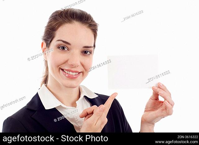 Smiling pretty business woman holding a blank card and pointing at it isolated over white background