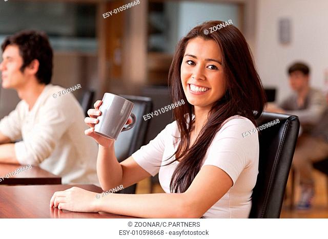 Cute woman having a coffee