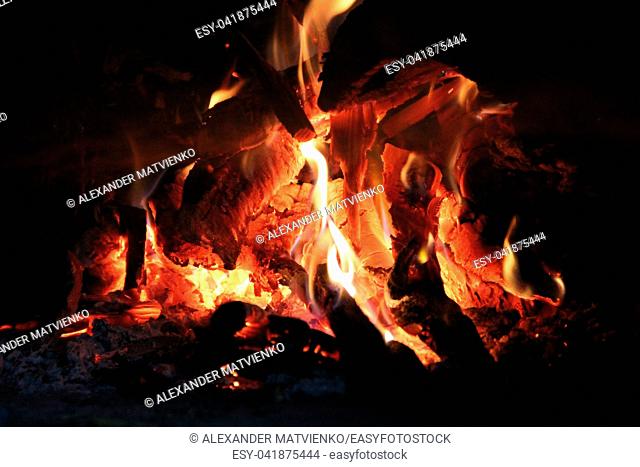 Fire wood brighly burning in furnace. Firewood burn in rural oven. Burning firewood in fireplace closeup. Fire and flames