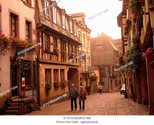 France, Europe, Alsace, Riquewihr, Haut-Rhin, L'Alsace Wine Region, Route du Vin, downtown, half-timbered buildings, cobblestone street, fog