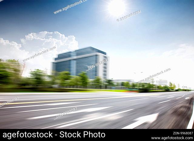 blurred empty city road in sunny sky