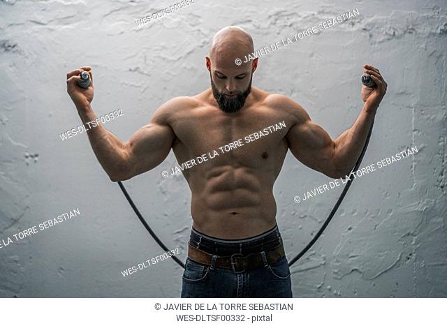 Portrait of a barechested athlete with rope
