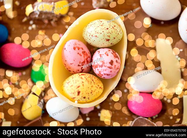 chocolate egg and candy drops on wooden table