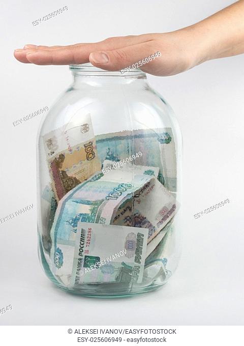 Hand covered the three-liter jar with Russian money