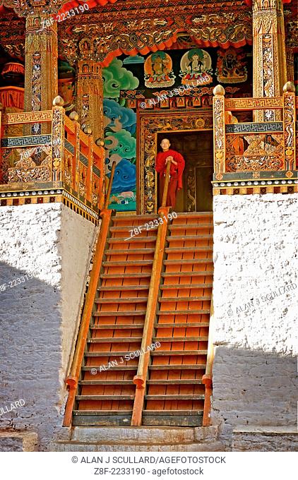 Buddhiist priest at the top of a decorated wooden staircase in Punakha Dzong (Temple) in Bhutan. Digitally Manipulated Image