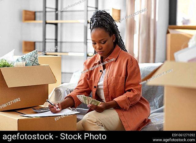 woman moving to new home and counting money