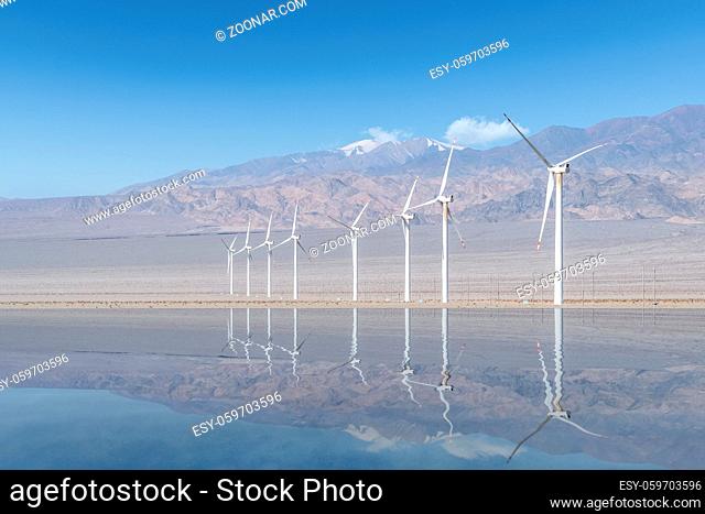 wind farm landscape, row of wind turbines by wilderness lake, qinghai province, China